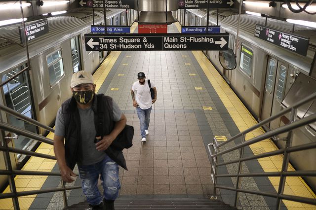 Commuters walk on a nearly empty subway platform in New York on June 8th, 2020.